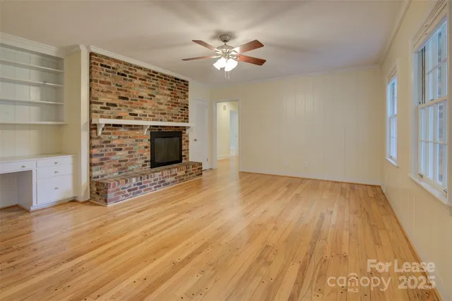 wooden floor in an empty room with a fireplace