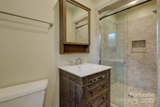 a bathroom with a sink toilet and shower