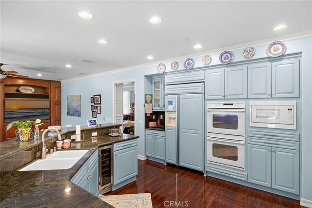 a kitchen with stainless steel appliances granite countertop a refrigerator and a stove top oven