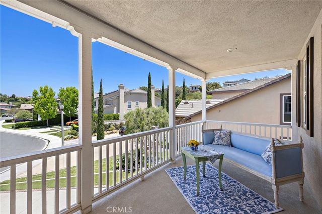 a balcony with furniture and a potted plant