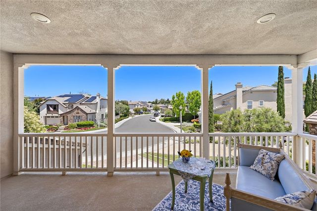 a view of a chairs and table in the balcony