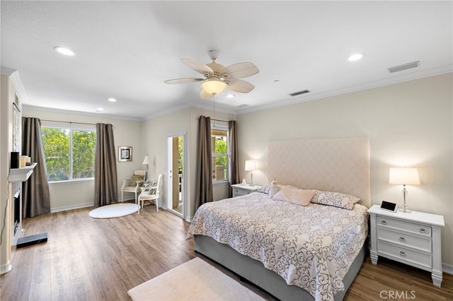 a spacious bedroom with a large bed and a chandelier
