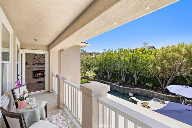 a view of a chairs and table in patio with a wooden fence