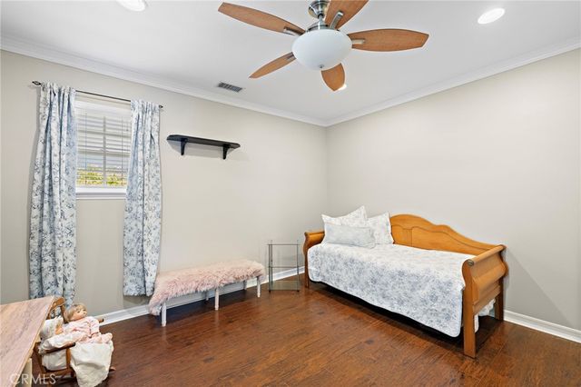 a living room with a bed furniture and a window
