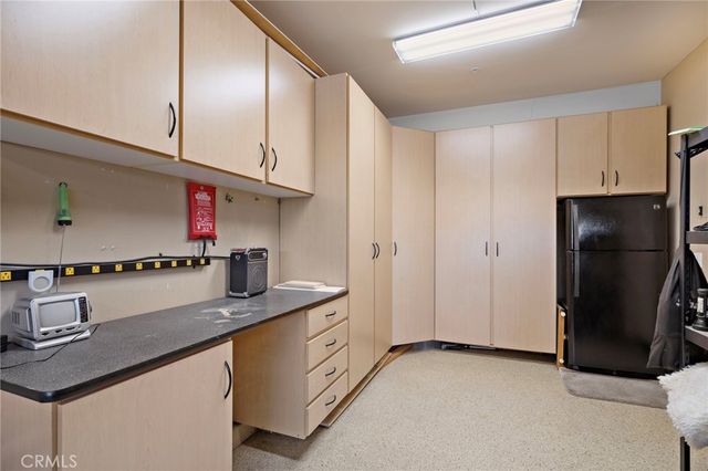 a kitchen with stainless steel appliances granite countertop a refrigerator a sink and a stove