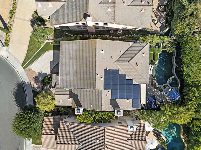 an aerial view of a house with a yard