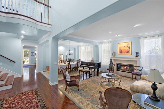 a living room with fireplace furniture and wooden floor