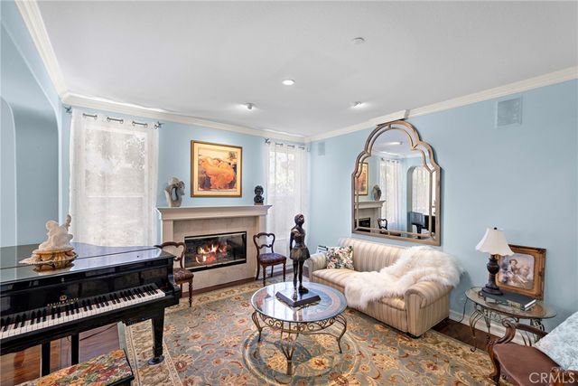 a living room with furniture a fireplace and a large mirror