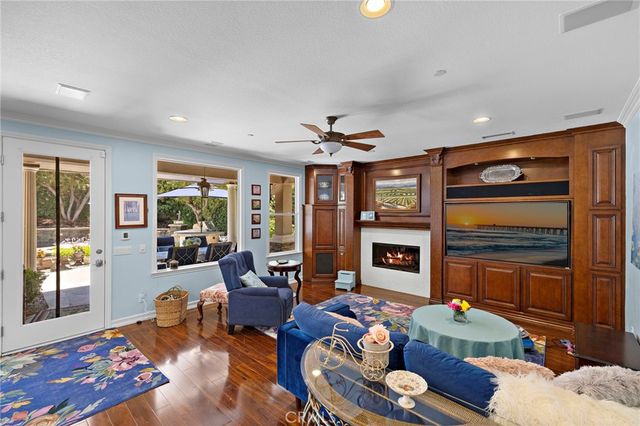 a living room with furniture fireplace and flat screen tv