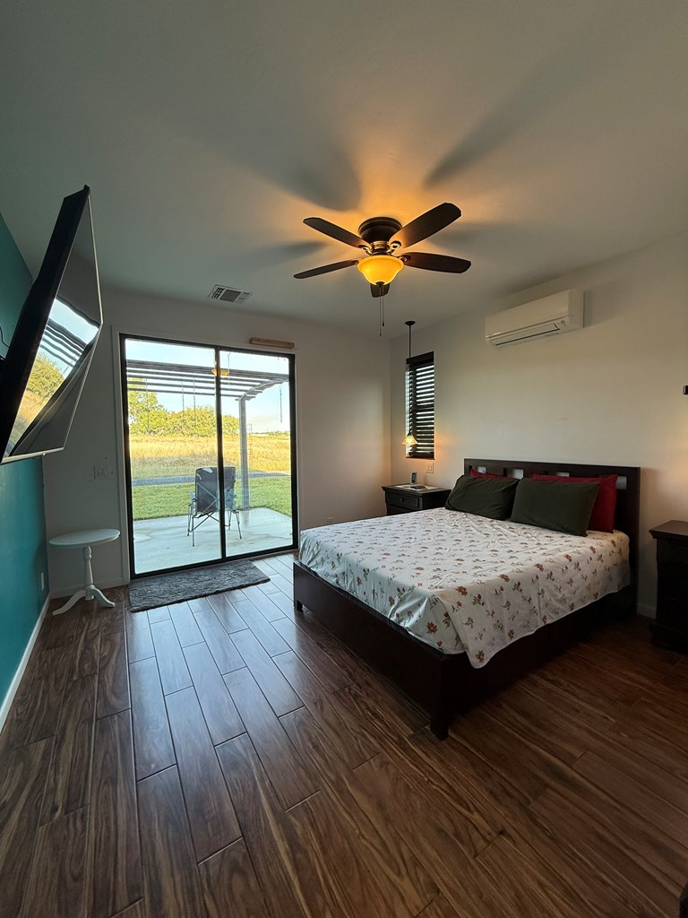 150 Dowling Road West Ingram, TX 78025 - Photo 16 of 33 a bedroom with a bed and a chandelier