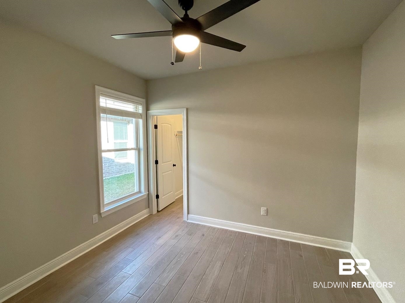 1392 Fenton Circle Foley, AL 36535 - Photo 11 of 17 Empty room with ceiling fan and light wood-type flooring