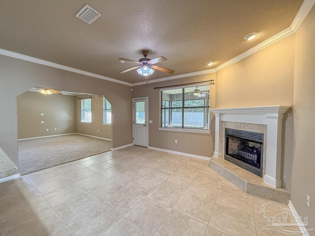 3554 Haley Way Pace, FL 32571 - Photo 12 of 40 a view of an empty room with a fireplace and a window