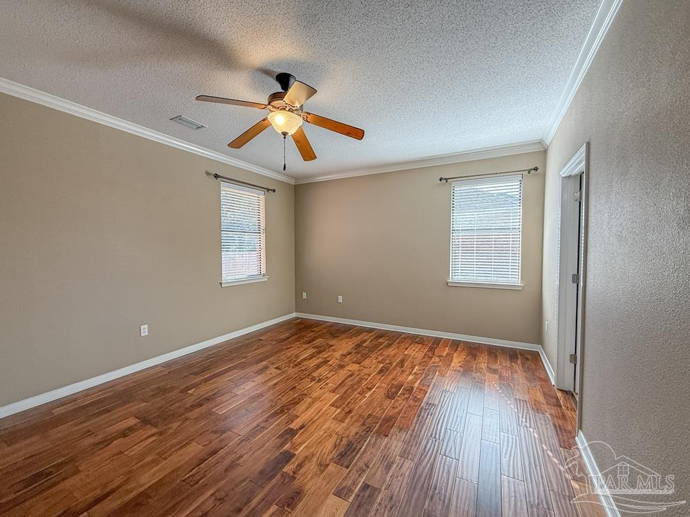 3554 Haley Way Pace, FL 32571 - Photo 17 of 40 wooden floor in an empty room with a window