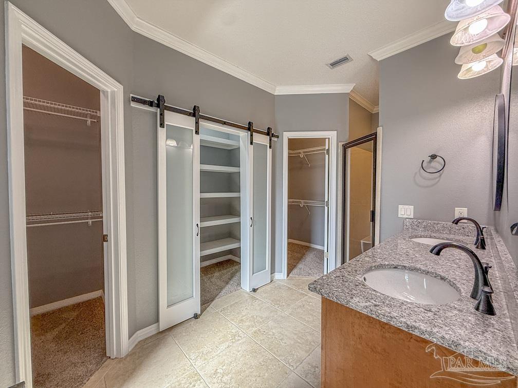 3554 Haley Way Pace, FL 32571 - Photo 19 of 40 a bathroom with a granite countertop sink shower and a mirror