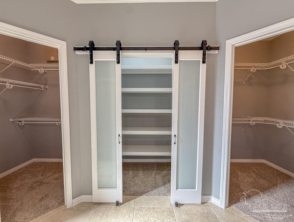 3554 Haley Way Pace, FL 32571 - Photo 20 of 40 a view of walk in closet with empty racks