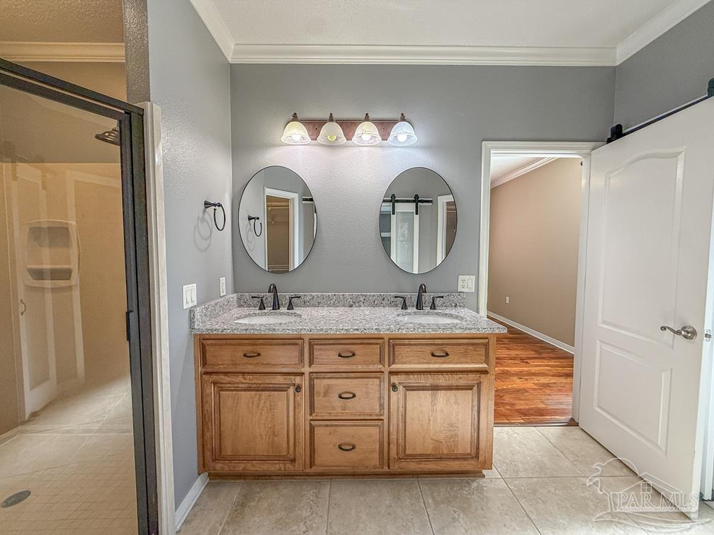 3554 Haley Way Pace, FL 32571 - Photo 21 of 40 a bathroom with a granite countertop double vanity sink and a mirror