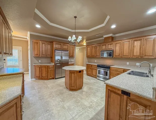 a kitchen with stainless steel appliances granite countertop a sink a counter space cabinets and stainless steel appliances
