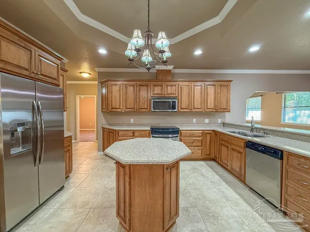 a view of a hallway with furniture and a window