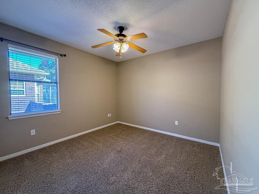 3554 Haley Way Pace, FL 32571 - Photo 28 of 40 an empty room with windows and fan