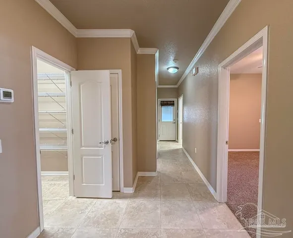 an empty room with window and chandelier fan