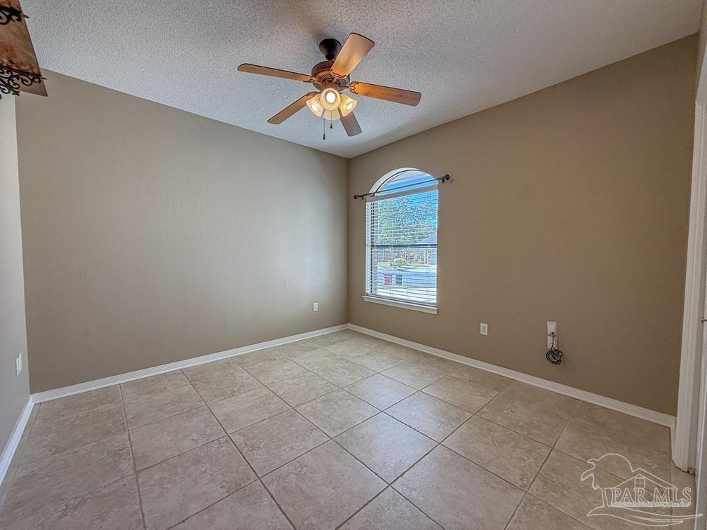 3554 Haley Way Pace, FL 32571 - Photo 34 of 40 an empty room with window and chandelier fan