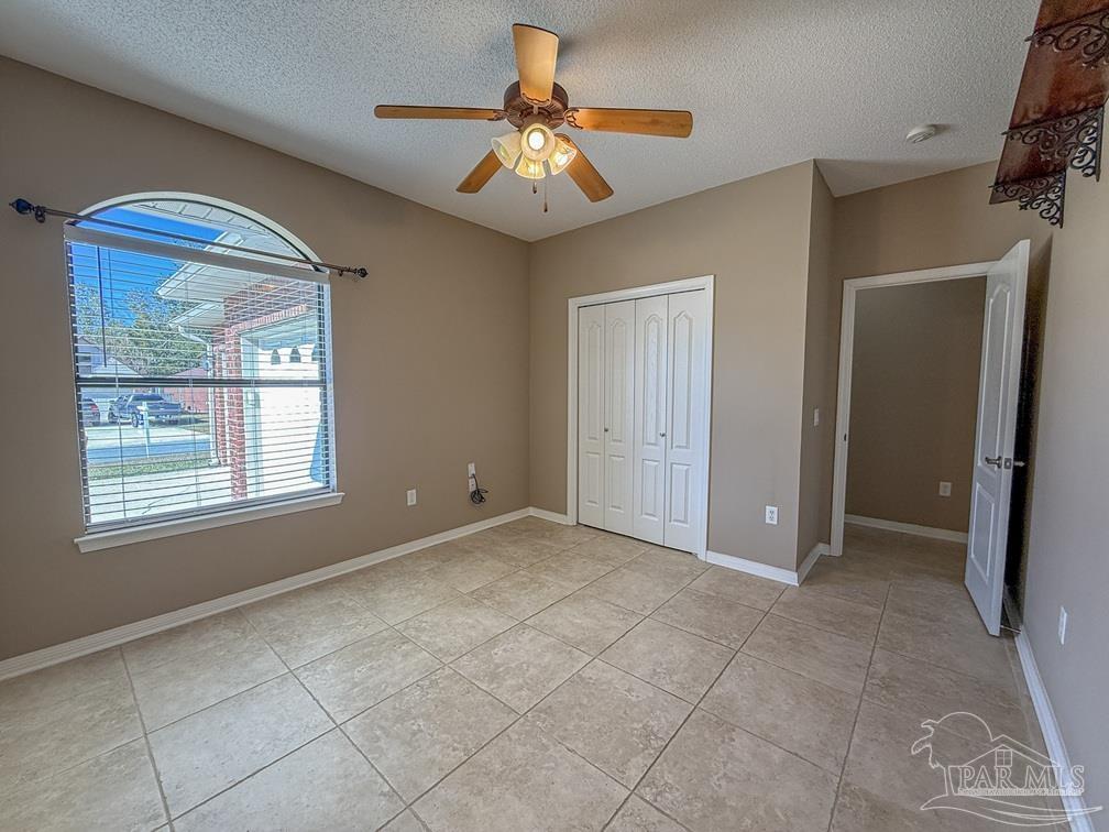 3554 Haley Way Pace, FL 32571 - Photo 35 of 40 a view of an empty room with window and chandelier fan
