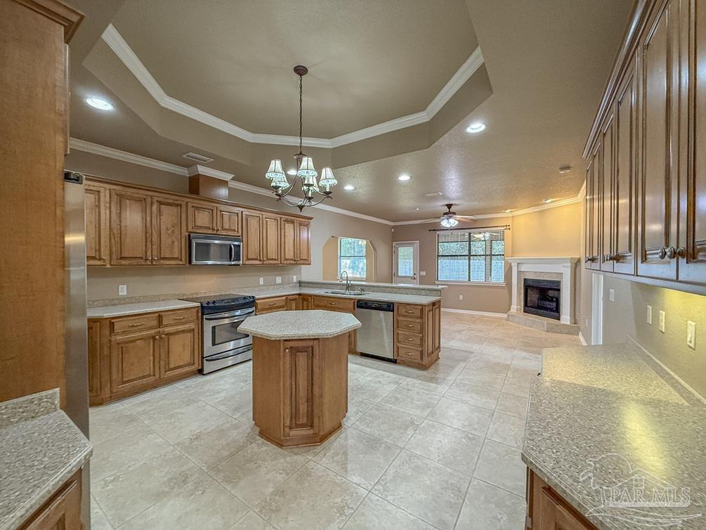 3554 Haley Way Pace, FL 32571 - Photo 8 of 40 a kitchen with stainless steel appliances granite countertop a sink stove and refrigerator