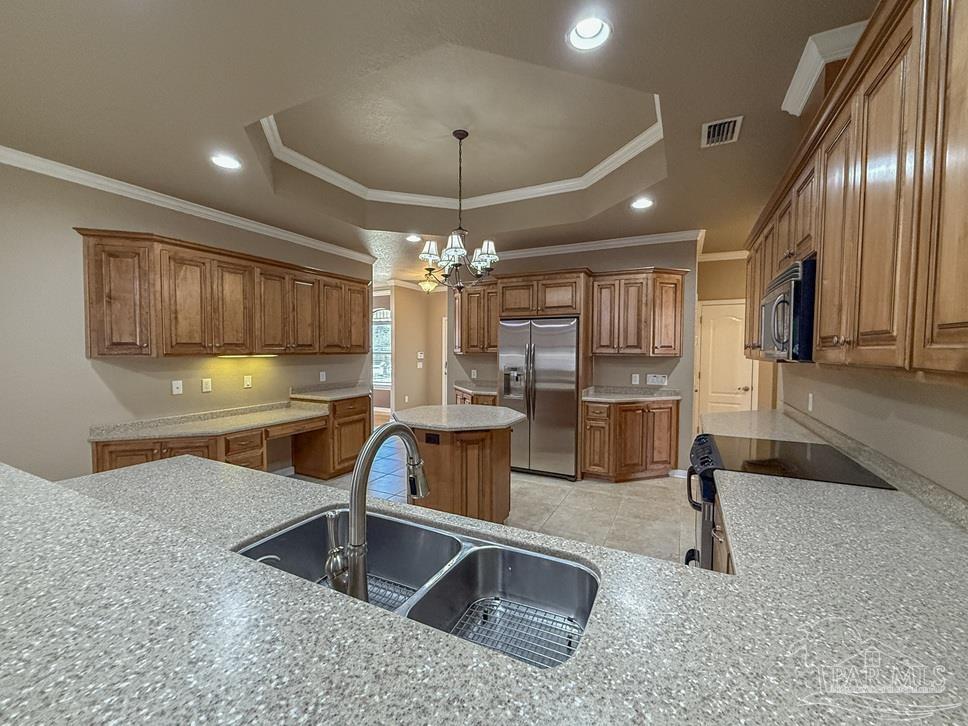 3554 Haley Way Pace, FL 32571 - Photo 10 of 40 a kitchen with stainless steel appliances granite countertop a sink a stove and a refrigerator