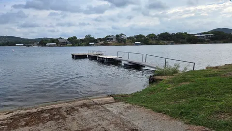 a view of a lake with boats and trees around
