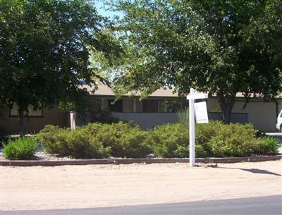 14656 Nanticoke Road Apple Valley, CA 92307 - Photo 1 of 1 a front view of a house with a yard and a garage