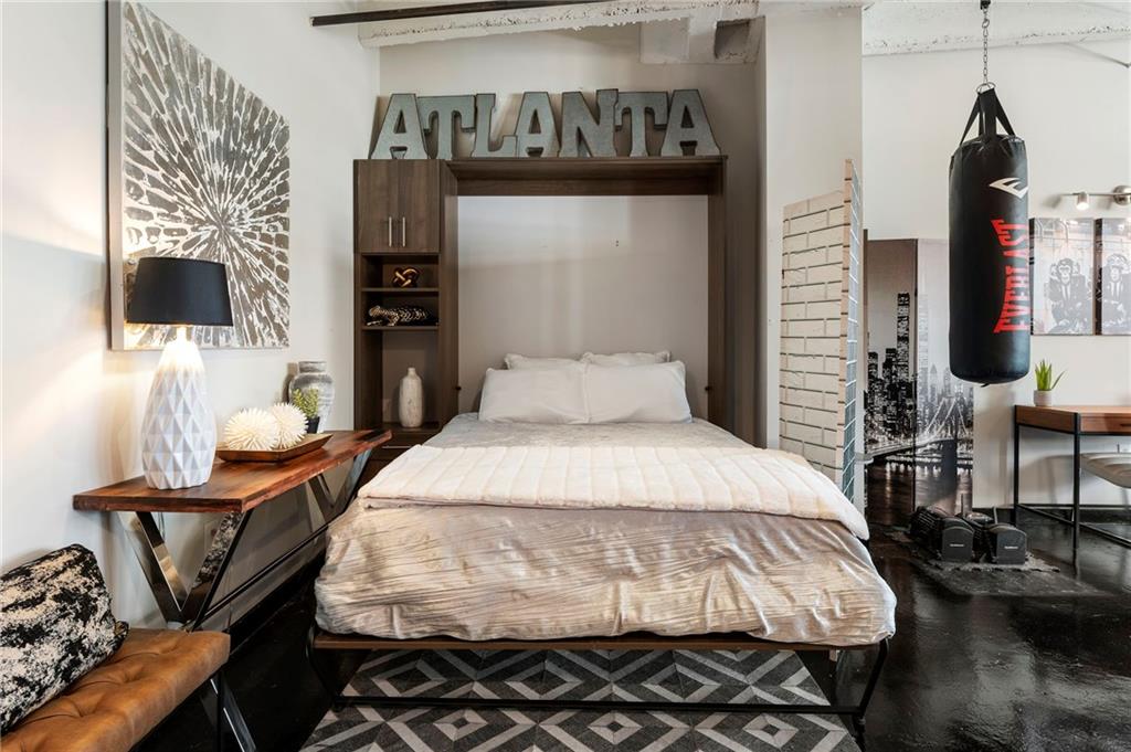 878 Peachtree Street Northeast, Unit 601 Atlanta, GA 30309 - Photo 26 of 43 a bed room with a bed and a television