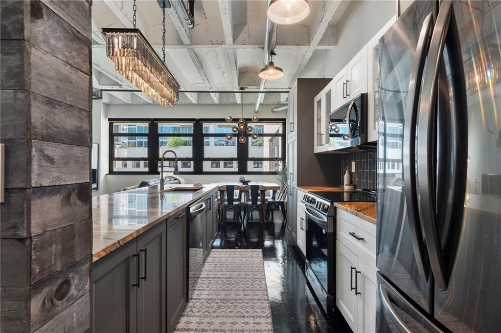 878 Peachtree Street Northeast, Unit 601 Atlanta, GA 30309 - Photo 5 of 43 a kitchen with stainless steel appliances granite countertop a large stove top oven
