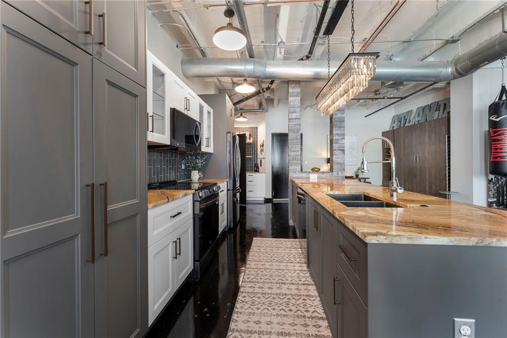 878 Peachtree Street Northeast, Unit 601 Atlanta, GA 30309 - Photo 6 of 43 a large kitchen with stainless steel appliances granite countertop a large stove a sink dishwasher and refrigerator