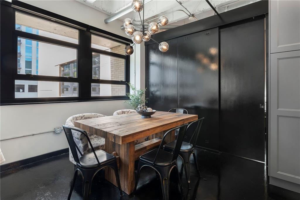 878 Peachtree Street Northeast, Unit 601 Atlanta, GA 30309 - Photo 8 of 43 a dining room with furniture a chandelier and window
