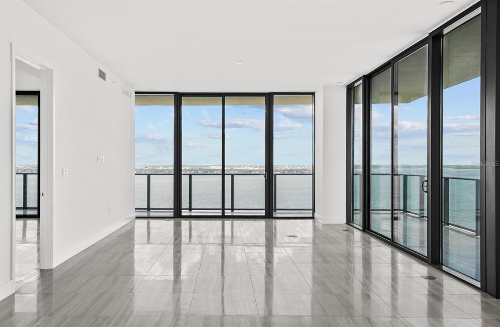 3101 Bayshore Boulevard, Unit 2004 Tampa, FL 33629 - Photo 12 of 64 a view of an empty room with wooden floor and a window