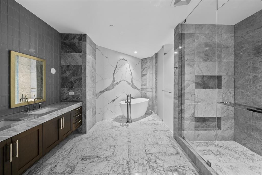 3101 Bayshore Boulevard, Unit 2004 Tampa, FL 33629 - Photo 27 of 64 a bathroom with a granite countertop sink a toilet and shower