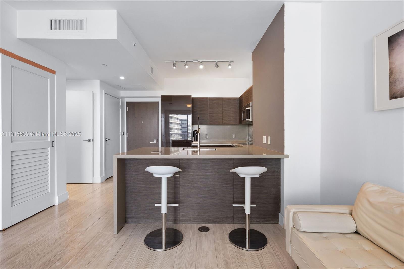 1080 Brickell Avenue, Unit 3705 Miami, FL 33131 - Photo 13 of 32 a kitchen with stainless steel appliances granite countertop a sink and cabinets