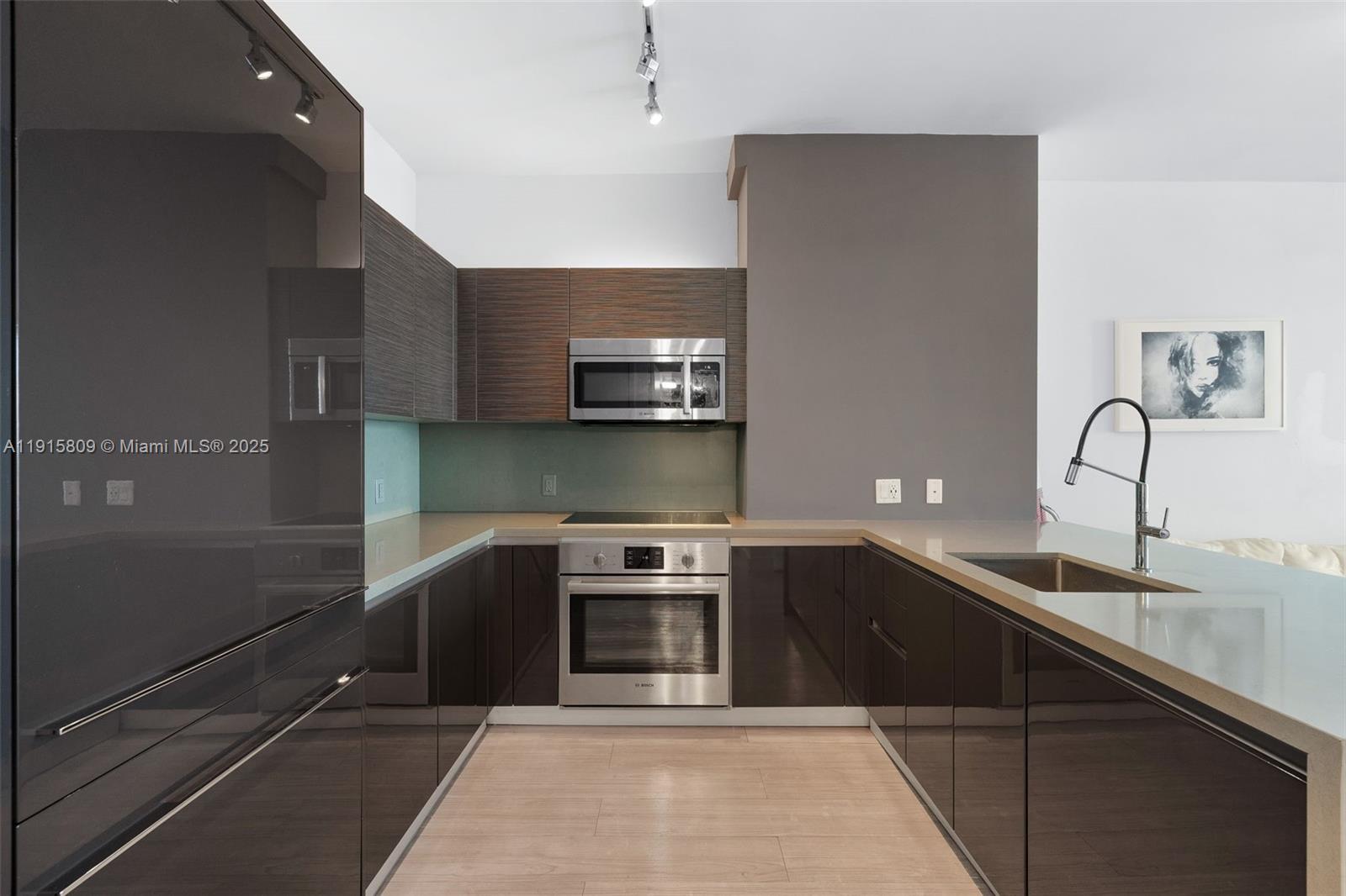 1080 Brickell Avenue, Unit 3705 Miami, FL 33131 - Photo 16 of 32 a kitchen with a sink and stainless steel appliances