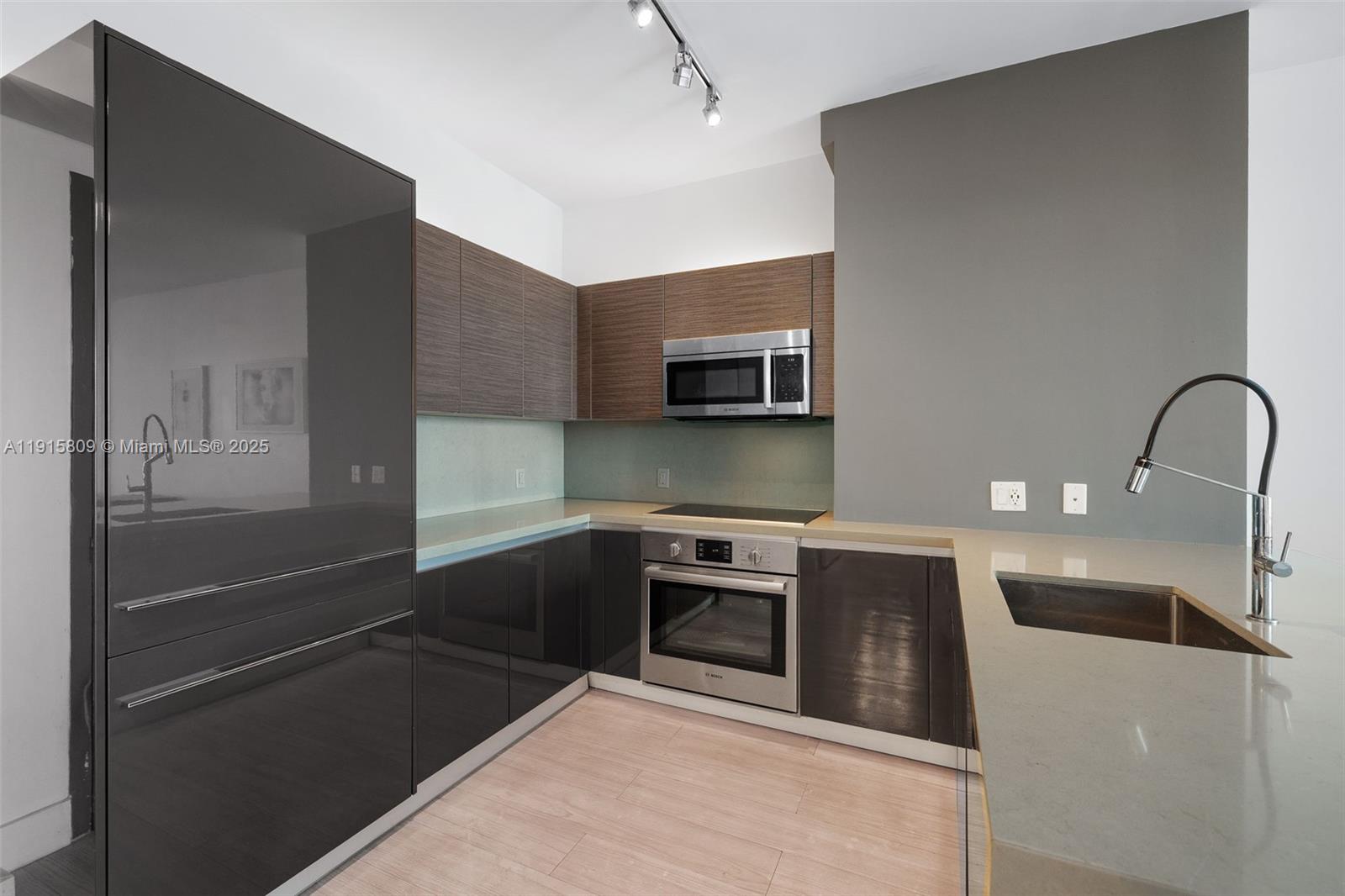 1080 Brickell Avenue, Unit 3705 Miami, FL 33131 - Photo 17 of 32 a kitchen with a sink and stainless steel appliances