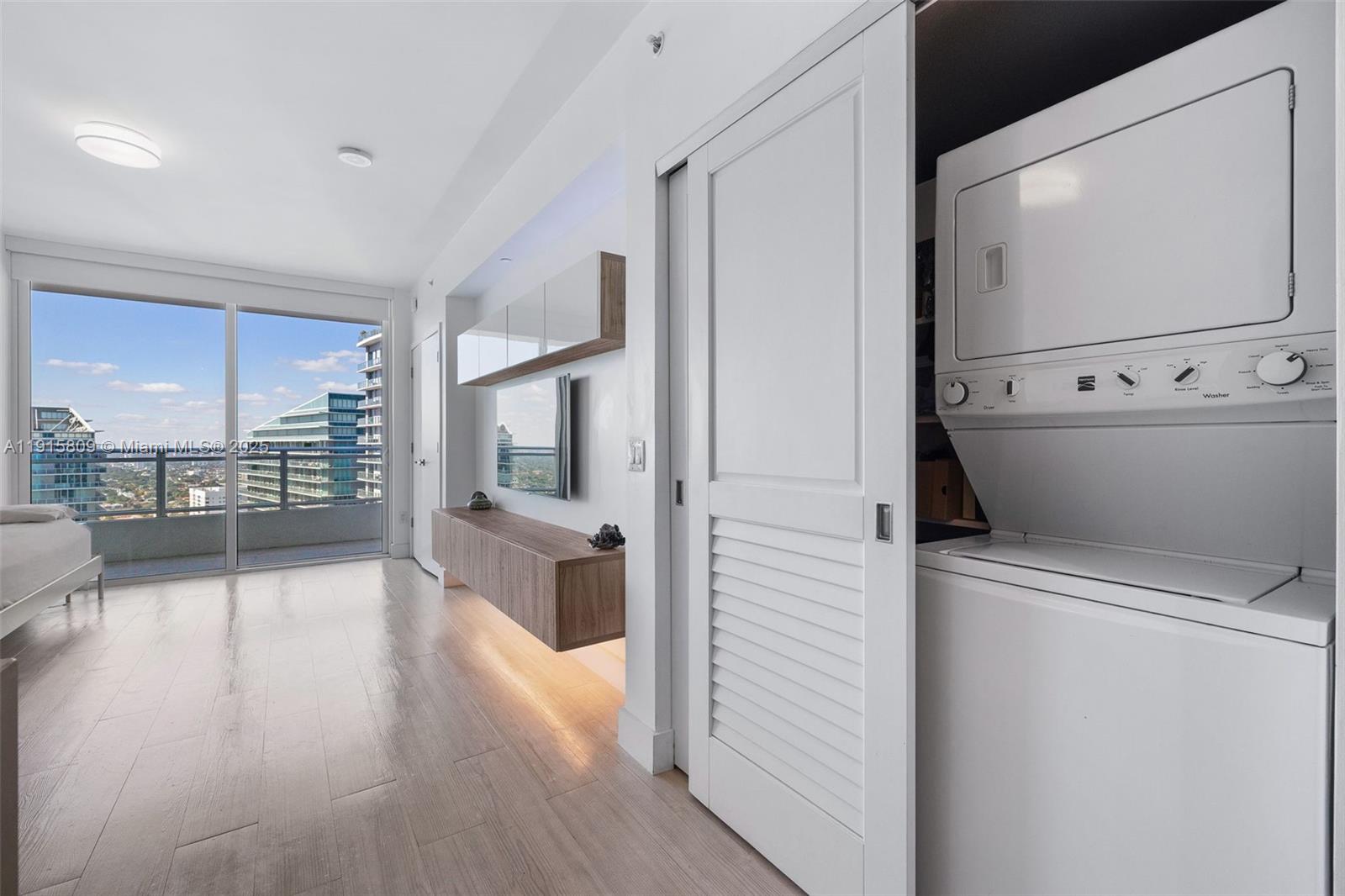 1080 Brickell Avenue, Unit 3705 Miami, FL 33131 - Photo 21 of 32 a view of washer and dryer with wooden floor