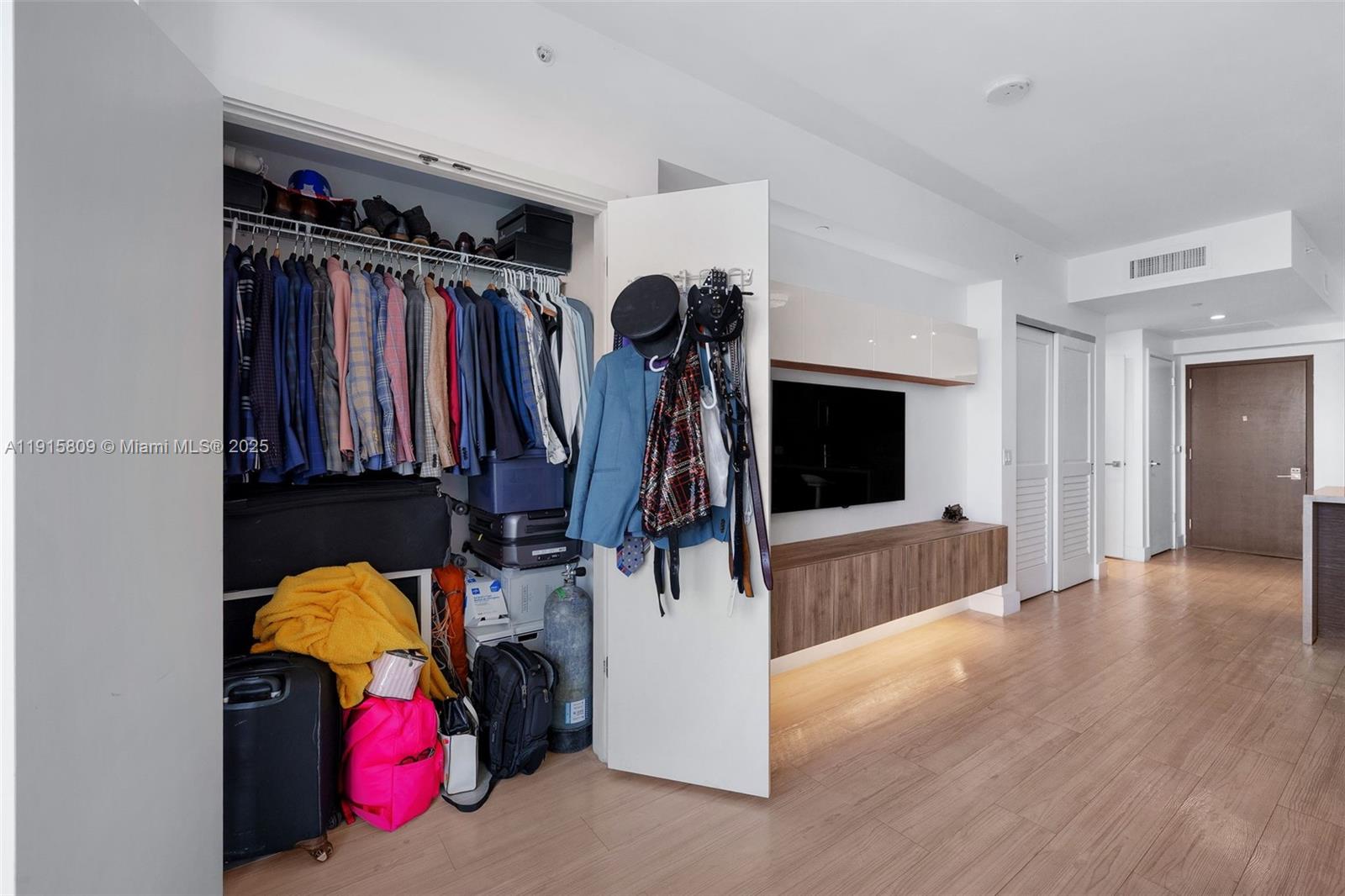 1080 Brickell Avenue, Unit 3705 Miami, FL 33131 - Photo 9 of 32 a view of walk in closet with clothes and shoes