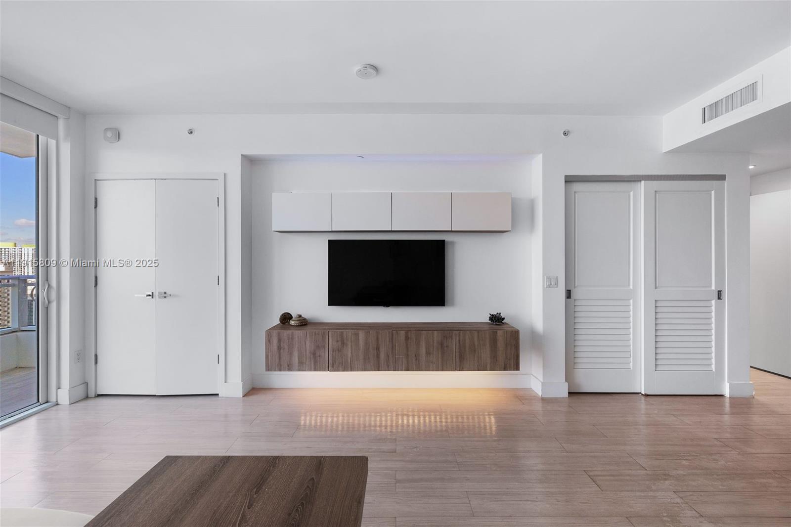 1080 Brickell Avenue, Unit 3705 Miami, FL 33131 - Photo 10 of 32 a view of kitchen with furniture and flat screen tv