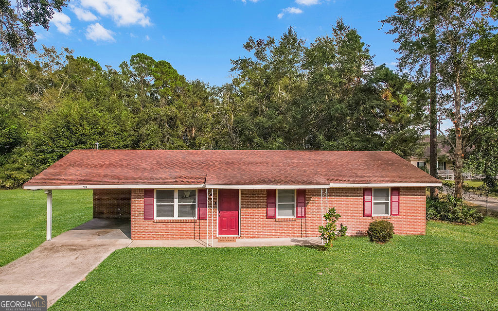979 B Pineland Avenue, Unit B Hinesville, GA 31313 - Photo 1 of 1 a front view of a house with a garden