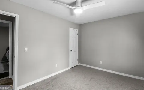 an empty room with windows and closet