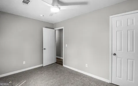 a bed sitting in a bedroom next to a window