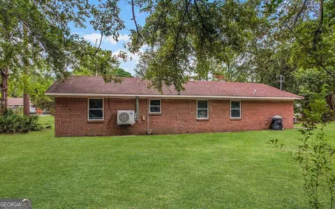 a view of an house with backyard space and garden