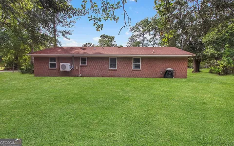 a front view of house with a garden