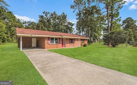 a view of house that has a yard
