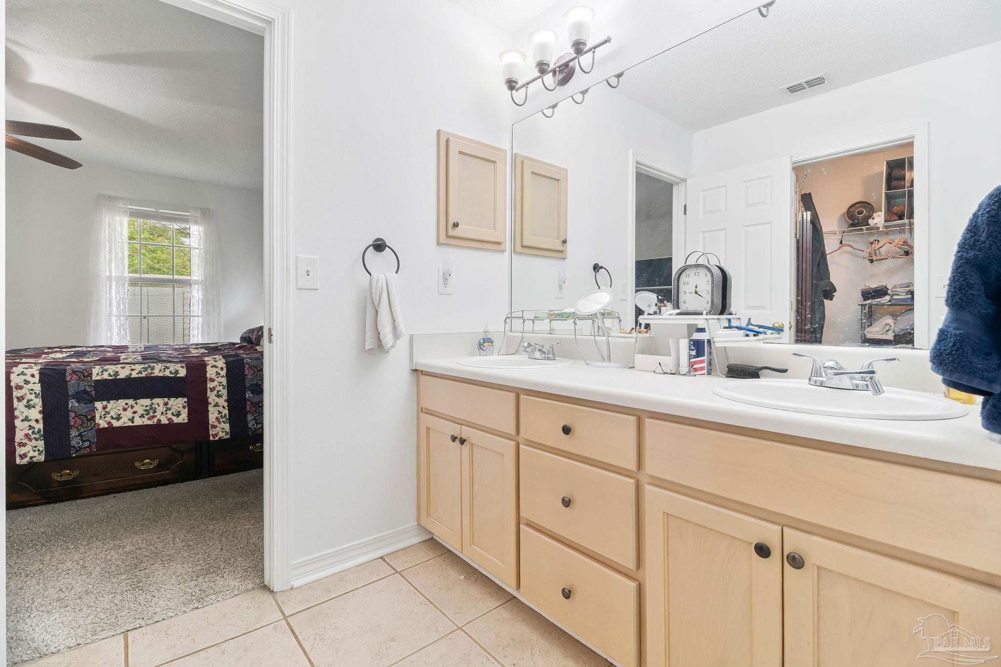 5691 Berrybrook Circle Pace, FL 32571 - Photo 13 of 22 a bathroom with a sink double vanity and a mirror