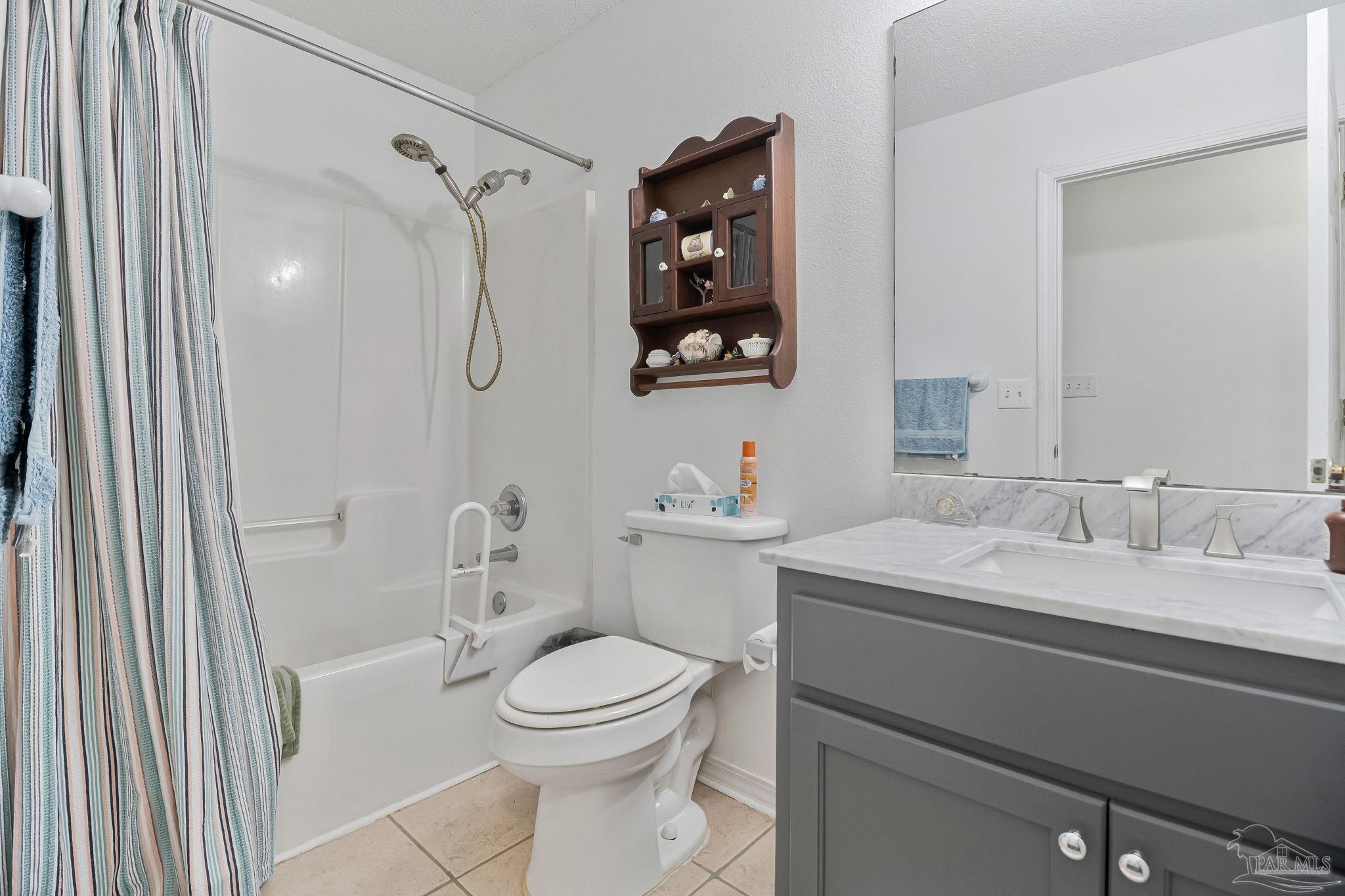 5691 Berrybrook Circle Pace, FL 32571 - Photo 14 of 22 a bathroom with a granite countertop sink mirror vanity and toilet
